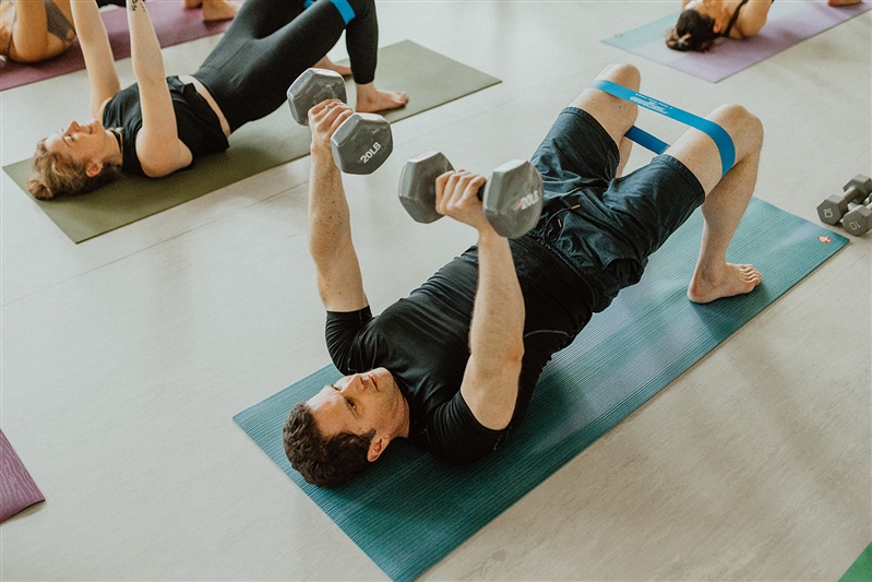 Hot Pilates floor dumbell press